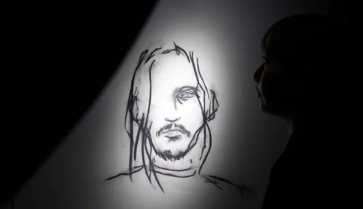 epa12551862 A visitor looks at artworks by Johnny Depp during the press preview of the exhibition 'A Bunch of Stuff' in Tokyo, Japan, 27 November 2025. The exhibition displays paintings, drawings, and other artworks and will be opened to the public from 28 November 2025. EPA/FRANCK ROBICHON