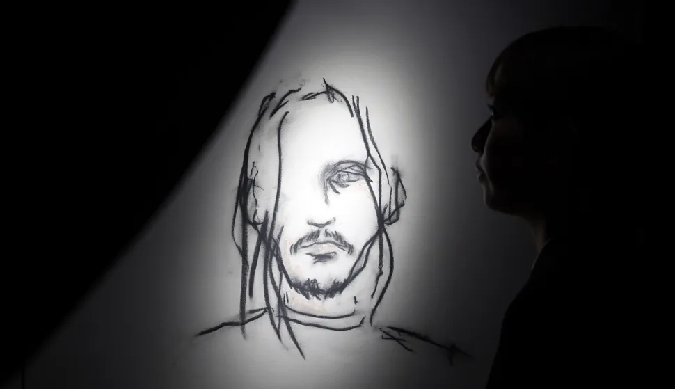 epa12551862 A visitor looks at artworks by Johnny Depp during the press preview of the exhibition 'A Bunch of Stuff' in Tokyo, Japan, 27 November 2025. The exhibition displays paintings, drawings, and other artworks and will be opened to the public from 28 November 2025. EPA/FRANCK ROBICHON