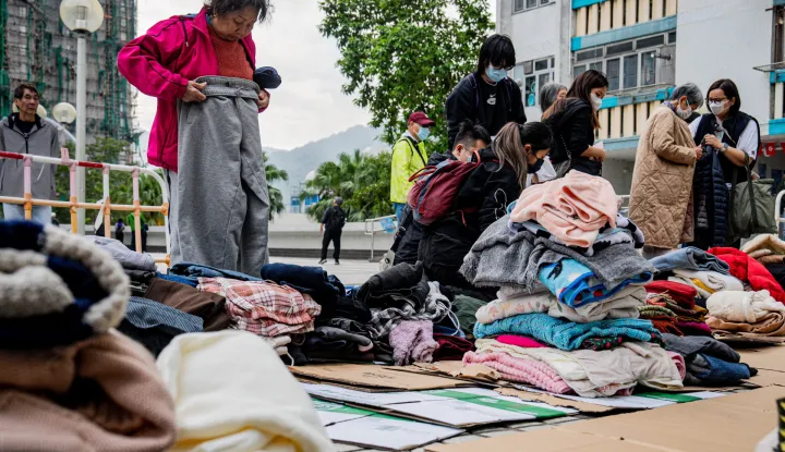 epa12551713 Displaced residents from an apartment fire in Tai Po district collect donated clothing in Hong Kong, China, 27 November 2025. The fire, which started on 26 November, has killed at least 44 people, and left 279 missing. EPA/LEUNG MAN HEI