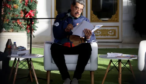 epa12541020 Venezuelan President Nicolas Maduro reads a paper at an event following a march for Venezuelan Student Day in Caracas, Venezuela, 21 November 2025. EPA/MIGUEL GUTIERREZ