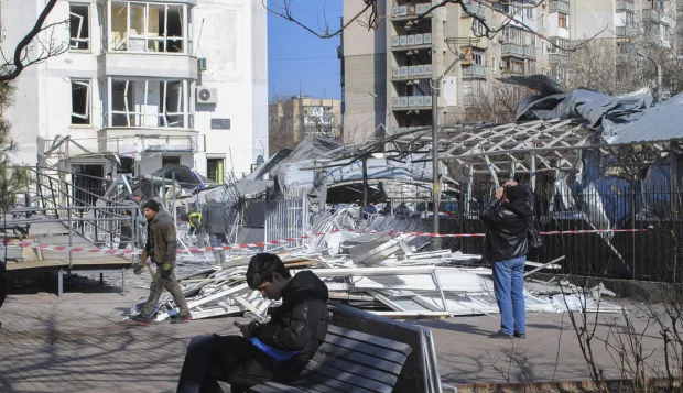 epa11907056 Local people stand near a damaged area after drone strikes hit Odesa, southwestern Ukraine, 19 February 2025, amid the Russian invasion. At least four people were injured, including a child, in Odesa as a result of an overnight Russian drone attack, the head of the Odesa Regional Military Administration, Oleh Kiper, wrote on telegram. Civilian infrastructure objects, including a children's clinic, a kindergarten, windows in high-rise buildings and cars, were damaged in the attack. EPA/IGOR TKACHENKO