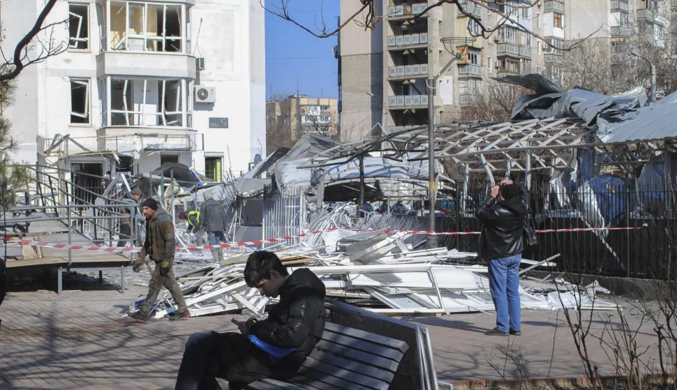 epa11907056 Local people stand near a damaged area after drone strikes hit Odesa, southwestern Ukraine, 19 February 2025, amid the Russian invasion. At least four people were injured, including a child, in Odesa as a result of an overnight Russian drone attack, the head of the Odesa Regional Military Administration, Oleh Kiper, wrote on telegram. Civilian infrastructure objects, including a children's clinic, a kindergarten, windows in high-rise buildings and cars, were damaged in the attack. EPA/IGOR TKACHENKO