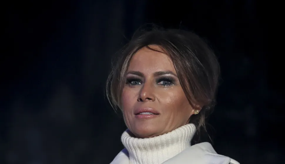 epa07196714 First lady Melania Trump listens as President Donald Trump speaks during the 2018 National Christmas Tree Lighting Ceremony at the Ellipse, near the White House in Washington, DC, USA, 28 November 2018. This is the 96th annual lighting ceremony. EPA/OLIVER CONTRERAS/POOL
