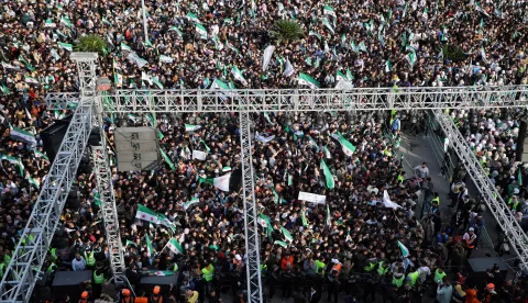 epa12572448 A general view shows hundreds of people gathered in Al-Assi Square during celebrations marking one year since the city's liberation, in Hama, Syria, 05 December 2025. Syria marks the first anniversary of the sudden collapse of Bashar al-Assad's regime on 08 December 2025, bringing to an end more than five decades of Baathist rule. According to the UN Human Rights Office, the civil war in Syria claimed more than 300.000 civilians' lives from March 2011 to March 2021. Millions of Syrians remain displaced inside the country and as refugees abroad. EPA/BILAL AL-HAMMOUD