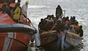 epa12530175 A Spanish Maritime Rescue vessel accompanies a boat carrying migrants to La Restinga Port, in La Restinga, El Hierro, Canary Islands, Spain, 16 November 2025. Sea rescue personnel rescued some 242 migrants traveling in two boats. EPA/GELMERT FINOL