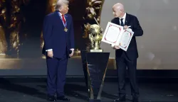 epa12572676 US President Donald Trump (L) receives the FIFA Peace Prize from FIFA President Giovanni Infantino during the FIFA World Cup 2026 Final Draw at the Kennedy Center in Washington DC, USA, 05 December 2025. EPA/WILL OLIVER