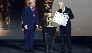 epa12572676 US President Donald Trump (L) receives the FIFA Peace Prize from FIFA President Giovanni Infantino during the FIFA World Cup 2026 Final Draw at the Kennedy Center in Washington DC, USA, 05 December 2025. EPA/WILL OLIVER