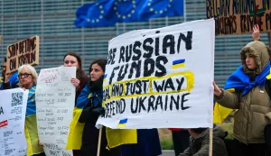 epa12586971 Ukrainians hold placards during a protest demanding the use of the frozen Russian assets, on the sidelines of the Economic and Financial Affairs Council (ECOFIN) meeting in Brussels, Belgium, 12 December 2025. Belgium has been blocking an EU plan to approve a large 'reparations loan' for Ukraine backed by frozen Russian state assets, because it fears major legal and financial risks since most of those assets are held in Brussels and is demanding stronger guarantees before it will agree to let the scheme go ahead. EPA/OLIVIER HOSLET