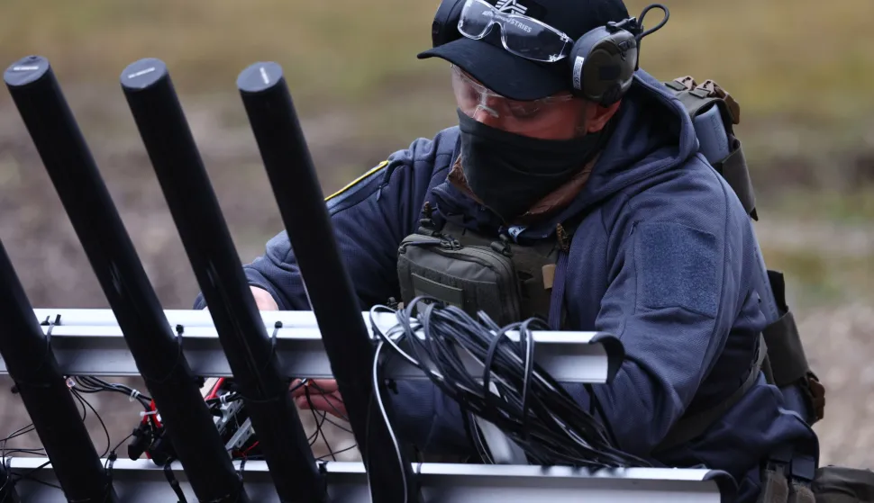 epa12569555 Team Fiberdome presents electromagnetic drone defense as their advanced prototype for defending against electronic attacks on unmanned systems on the final day of the Spectra Challenge in Erding, Germany, 04 December 2025. The Spectra Challenge, a joint initiative of the Agency for Innovation in Cybersecurity GmbH (Cyber ​​Agency), the German Armed Forces' Cyber ​​Innovation Hub (CIHBw), and the Innovation Lab System Soldier (InnoLabSysSdt), promotes technological innovations for protecting drones and other autonomous systems from electronic threats such as jamming, spoofing, and signal interception. The goal is to effectively integrate research and application in order to develop operational protection mechanisms in a short timeframe. EPA/ANNA SZILAGYI