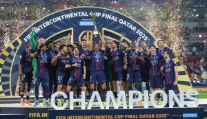 TOPSHOT - PSG's players celebrate on the podium after winning the 2025 FIFA Intercontinental Cup final football match between Paris Saint-Germain (PSG) and CR Flamengo at the Ahmad bin Ali Stadium in Al-Rayyan on the outskirts of Doha on December 17, 2025. (Photo by Karim JAAFAR/AFP)