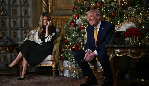 US President Donald Trump and first lady Melania Trump participate in NORAD Santa tracker phone calls, on Christmas Eve, from the Mar-a-lago club in Palm Beach, Florida, on December 24, 2025. (Photo by ANDREW CABALLERO-REYNOLDS/AFP)