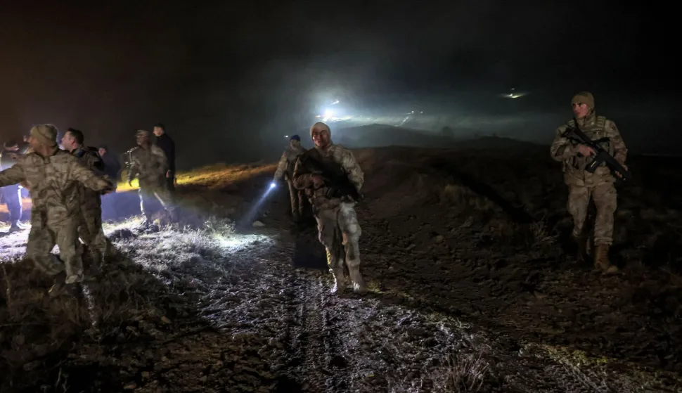 Turkish soldiers evacuate journalists and bystanders from the wreckage site as search and rescue operations are ungoing following the crash of a Libya-bound business jet carrying Libyan Chief of Staff General Muhammad Ali Ahmed Al-Haddad, found 2 kilometers south of Kesikkavak Village at Haymana district in Ankara on December 23, 2025. The head of Libya's armed forces and four other passengers died on December 23, 2025, when their business jet crashed shortly after taking off from Ankara, officials in Turkey's capital and Tripoli said. The wreckage of their Falcon 50 aircraft was located by Turkish security personnel in the Haymana district near Ankara, Turkey's Interior Minister said. (Photo by ADEM ALTAN/AFP)