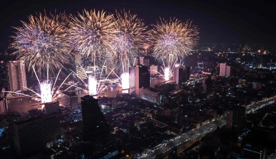 Fireworks light up the midnight sky over the Chao Phraya River during 2026 New Year's Day celebrations in Bangkok on January 1, 2026. (Photo by Chanakarn Laosarakham/AFP)