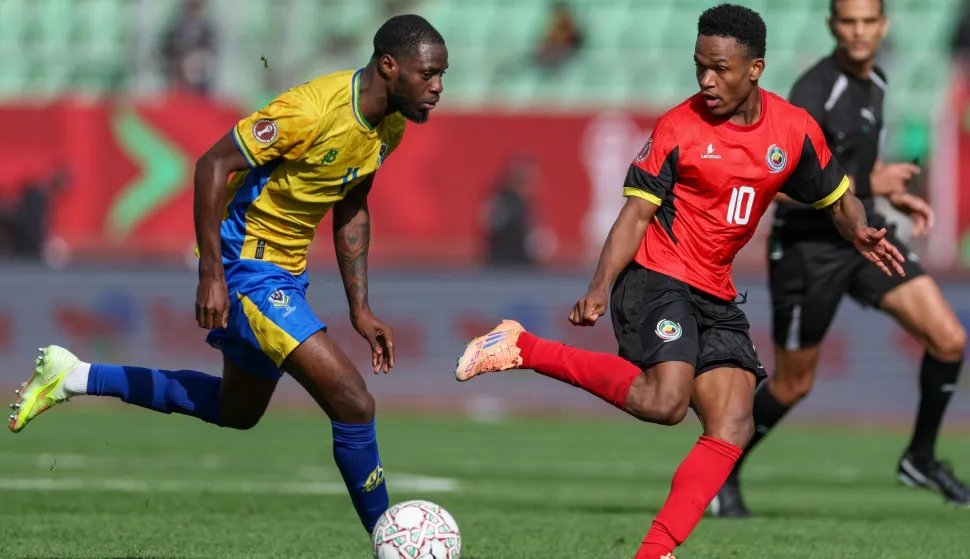 Gabon's defender #04 Alex Moucketou-Moussounda and Mozambique's midfielder #10 Geny Catamo vie during the Africa Cup of Nations (CAN) Group F football match between Gabon and Mozambique at Grand Stadium in Agadir on December 28, 2025. (Photo by FRANCK FIFE/AFP)