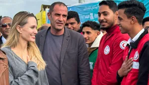 US actress Angelina Jolie greets an employee of the the Egyptian Red Crescent at the Egyptian Rafah border crossing, part of her visit to the North Sinai Governorate to inspect aid entering the Palestinian Gaza Strip, on January 2, 2026, following a two year war that was sparked by Hamas's October 7, 2023 attack on Israel, and which has left the majority of Gaza's 2.4 million people displaced and in need of aid. (Photo by AFP)