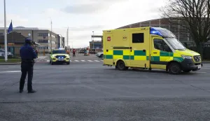 An ambulance leaves the Melsbroek military airport in Moelsbroek on January 2, 2026, as Belgium has offered its assistance to Switzerland after a fire ripped through a bar during New Year's Eve celebrations in the Alpine ski resort town of Crans-Montana, by taking in four injured people to provide them with specialised medical care. Investigators raced on January 2, 2026 to identify the victims of a fire that ripped through a bar in the Swiss Alps town of Crans-Montana, turning a New Year's celebration into one of the country's worst tragedies. Frederic Gisler, police commander in the Wallis canton in southwestern Switzerland, told reporters that authorities had counted "around 40 people who have died and around 115 injured, most of them seriously". (Photo by NICOLAS MAETERLINCK/Belga/AFP)/Belgium OUT