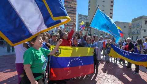 Cubans hold Venezuelan national flags during a gathering in support of Venezuelan leader Nicolas Maduro in Havana on January 3, 2026, after US forces captured him. President Donald Trump said Saturday that US forces had captured Venezuela's leader Nicolas Maduro after bombing the capital Caracas and other cities in a dramatic climax to a months-long standoff between Trump and his Venezuelan arch-foe. (Photo by ADALBERTO ROQUE/AFP)