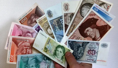 Deutschmarks&nbsp;are held up at a branch of the German Central Bank in Rostock,&nbsp;Germany, 23 December 2013.&nbsp;Every year in Germany, millions worth of Deutschmarks are still being exchanged for euros. Photo: Bernd&nbsp;Wuestneck/DPA/PIXSELL