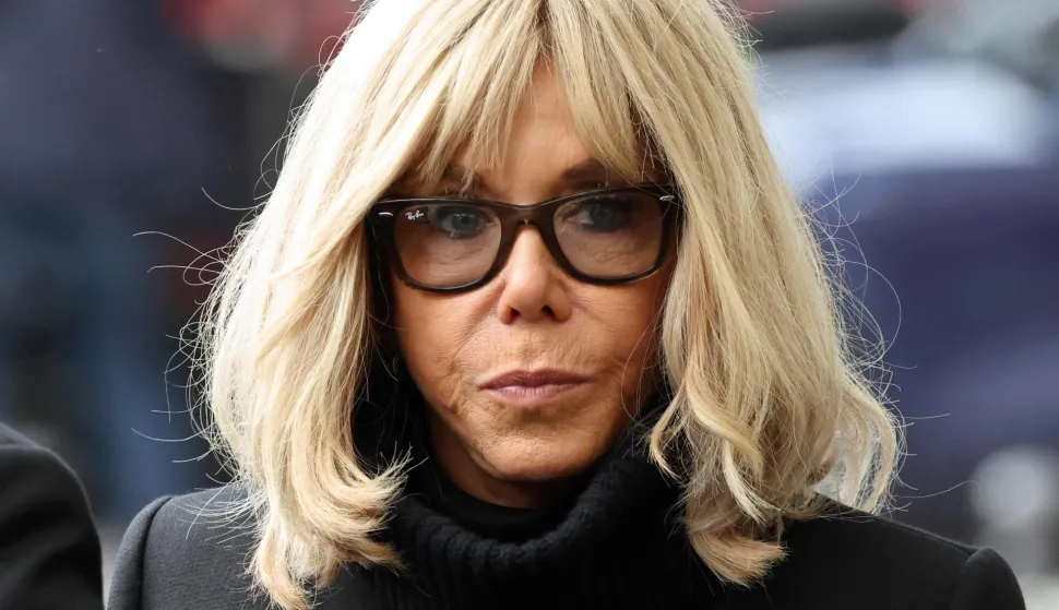 (FILES) French President's wife Brigitte Macron arrives ahead of the ceremony outside "La Belle Equipe" bar in Paris on November 13, 2025 during ceremonies across Paris marking a decade since the terror attacks of November 13, 2015 in which 130 civilians were killed. The verdict for the case of 10 people accused of the cyber-harassment of French President's wife is set for January 5, 2026. (Photo by Ludovic MARIN/POOL/AFP)