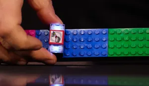 The LEGO SMART Brick is demonstrated during the LEGO press conference ahead of the annual Consumer Electronics Show (CES) in Las Vegas, Nevada on January 5, 2026. (Photo by Patrick T. Fallon/AFP)