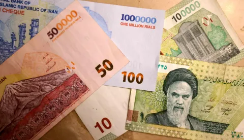 (FILES) This picture shows new Iranian bank notes of one million, 500,000, and 100,000 rials on August 3, 2025. Protesters and security forces clashed in several Iranian cities on January 1, 2026, with six reported killed, the first deaths since the cost-of-living demonstrations broke out. The national currency, the rial, has lost more than a third of its value against the US dollar over the past year, while double-digit hyperinflation has been undermining Iranians' purchasing power for years. The inflation rate in December 2025 was 52 percent year-on-year, according to the Statistical Centre of Iran, an official body. (Photo by ATTA KENARE/AFP)