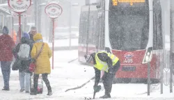 A public transport worker clears the tram tracks during snowfall in Vienna, Austria, on January 9, 2026. (Photo by Joe Klamar/AFP)