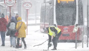 A public transport worker clears the tram tracks during snowfall in Vienna, Austria, on January 9, 2026. (Photo by Joe Klamar/AFP)
