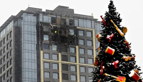 This photograph shows a Christmas tree at a residential building under construction damaged during massive Russian drones and missiles attack to Kyiv on January 9, 2026, amid Russian invasion in Ukraine. (Photo by Sergei SUPINSKY/AFP)