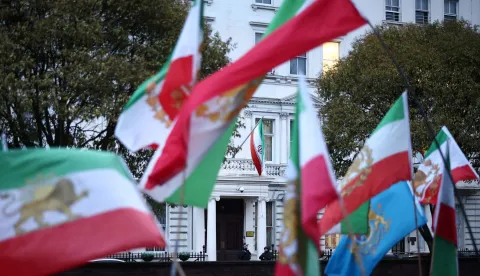 Anti-Iranian regime protesters wave the Iranian flag before the 1979 revolution with the Lion and Sun emblems during a gathering outside the Iranian Embassy, central London, on January 9, 2026. Iran FM says US, Israel 'directly intervening' in protests. Iran's foreign minister accused the United States and Israel on Friday of fuelling a growing protest movement in the country, while dismissing the possibility of direct foreign military intervention after US warnings over crackdowns on demonstrators. (Photo by HENRY NICHOLLS/AFP)
