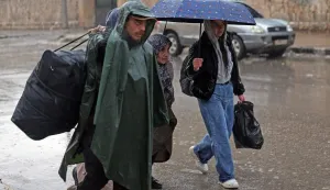 Residents of Aleppo's Sheikh Maqsoud area evacuate their neighbourhood after warnings from the Syrian army that called on civilians to get out of harms way, following the refusal of Kurdish fighter forces to leave Aleppo, on January 9, 2026. Syria's army warned on January 9 it would renew attacks against a Kurdish-majority district of Aleppo and urged residents to evacuate, state media reported, hours after a ceasefire was announced. (Photo by OMAR HAJ KADOUR/AFP)