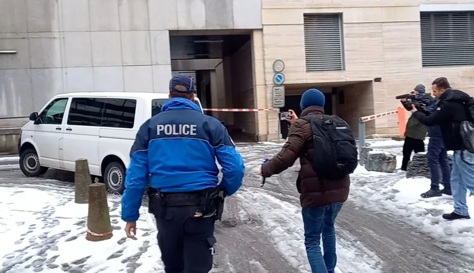 This video grab shows a penitentiary vehicle carrying Jacques Moretti, co-owner of the Swiss bar that went up in flames during New Year's Eve celebrations, leaving the Office of the Public Prosecutor of the Canton of Valais in Sion on January 9, 2026, after he was held in custody and questioned. The French couple, facing charges of manslaughter by negligence, bodily harm by negligence and arson by negligence, have been called in for questioning after 40 people, most of them teenagers, were killed, while 116 were injured in a fire that ripped through a bar in the luxury Alpine ski resort of Crans-Montana on New Year's Eve. (Photo by Agn?s PEDRERO/AFP)
