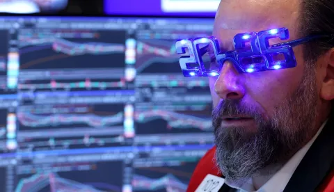 Trader Michael Pistillo wears "2026" glasses as he works on the floor of the New York Stock Exchange (NYSE) at the opening bell in New York on December 31, 2025. Wall Street's main indexes pulled back slightly on Wednesday, in a mild retreat that still sets the stage for a robust showing for all of 2025. (Photo by TIMOTHY A. CLARY/AFP)