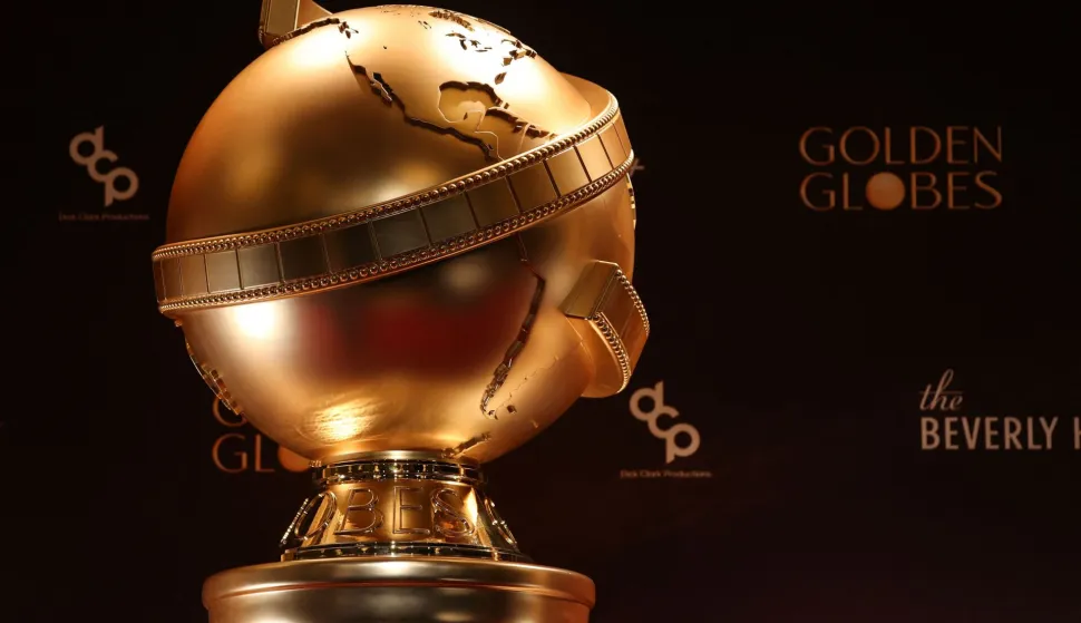 (FILES) An oversized Golden Globe Award is displayed ahead of the nominations announcement event for the 83rd Golden Globe Awards in Beverly Hills, California, on December 8, 2025. Hollywood's awards season kicks into high gear on Sunday with the Golden Globes gala, with the politically charged "One Battle After Another" expected to solidify its status as the film to beat, two months ahead of the Oscars. Paul Thomas Anderson's screwball thriller, which centers on an aging revolutionary (Leonardo DiCaprio) and his teenage daughter (Chase Infiniti), is a rollicking ride featuring violent leftist radicals, immigration raids and white supremacists. At a time when the United States is deeply polarized, many critics and pundits have hailed the film as capturing the moment. (Photo by Patrick T. Fallon/AFP)