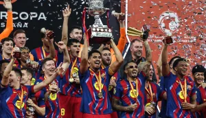 Barcelona's players raise the trophy as they celebrate after winning the Spanish Super Cup final football match between FC Barcelona and Real Madrid at the King Abdullah Stadium?in Jeddah on January 11, 2026. (Photo by Fadel SENNA/AFP)