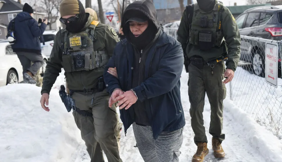 US Customs and Border Protection agents arrest a man after not providing documents proving he?s a citizen of the United States while patrolling a neighborhood during immigration enforcement activity in Minneapolis in Minneapolis, Minnesota, on January 11, 2026. A US Immigration and Customs Enforcement (ICE) agent shot and killed 37-year-old Renee Nicole Good on the streets of Minneapolis on January 7, leading to huge protests and outrage from local leaders who rejected White House claims she was a domestic terrorist. (Photo by Octavio JONES/AFP)
