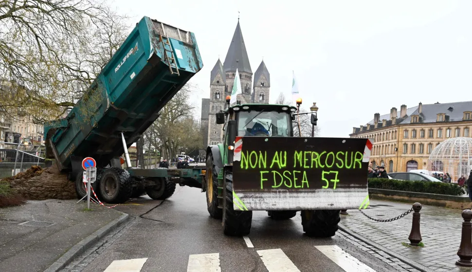 A farmer dumps manure on the street during a demonstration of French farmers to protest against EU-Mercosur agreements, in Hauconcourt, northeastern France on January 12, 2026. (Photo by Jean-Christophe VERHAEGEN/AFP)