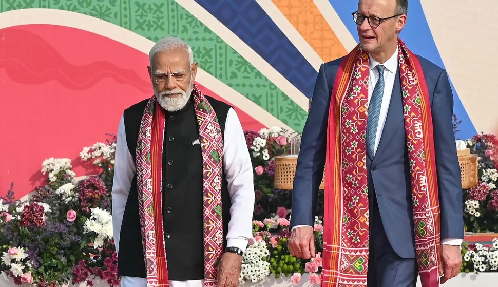 India's Prime Minister Narendra Modi (L) walks alongside German Chancellor Friedrich Merz during the International Kite Festival in Ahmedabad on January 12, 2026. (Photo by Shammi MEHRA/AFP)