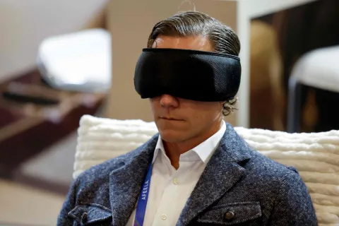 A man tries on Hypnuse?s AI sleep mask-pro at the annual Consumer Electronics Show (CES) in Las Vegas, Nevada, on January 6, 2026. (Photo by Caroline Brehman/AFP)