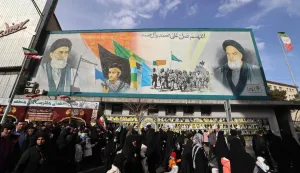 People walk past a banner depicting Iran?s Supreme Leader Ayatollah Ali Khamenei and late leader Ruhollah Khomeini on Enghelab (Revolution) Square in Terhan on January 14, 2026. Iran on Januray 14 vowed fast-track trials for people arrested over a massive wave of protests, after US President Donald Trump threatened "very strong action" if the Islamic republic goes ahead with hangings. In Tehran, authorities held a funeral ceremony for over 100 members of the security forces and other "martyrs" killed in the demonstrations, which authorities have branded as "riots" while accusing protesters of waging "acts of terror". (Photo by ATTA KENARE/AFP)