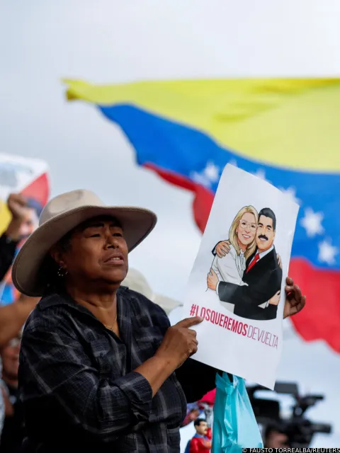 A supporter holds a poster depicting Venezuela's deposed President Nicolas Maduro and his wife, Cilia Flores, during a march calling for their release, following their capture by U.S. forces during U.S. strikes on Venezuela, in Caracas, Venezuela, January 10, 2026. REUTERS/Fausto Torrealba Photo: FAUSTO TORREALBA/REUTERS