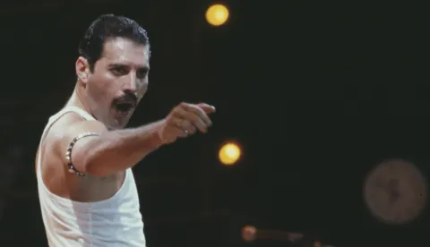 File photo dated 13/7/1985 of Freddie Mercury, of the pop band Queen, performing on stage during the Live Aid concert. British rock legends Queen have made history by becoming the first album to surpass seven million UK chart sales. The record was broken by Queen's Greatest Hits album, recorded in 1981, which includes classic tracks such as We Will Rock You, Don't Stop Me Now and Bohemian Rhapsody. Issue date: Tuesday July 19, 2022. Photo: PA/PRESS ASSOCIATION