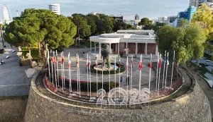 This aerial picture shows flags of EU member states adorning a section of the Venetian Walls of the divided capital Nicosia, on the grounds of the old municipal palace at Eleftheria Square on January 2, 2026. The Republic of Cyprus will hold the Presidency of the Council of the European Union for the first half of 2026. (Photo by Etienne TORBEY/AFP)