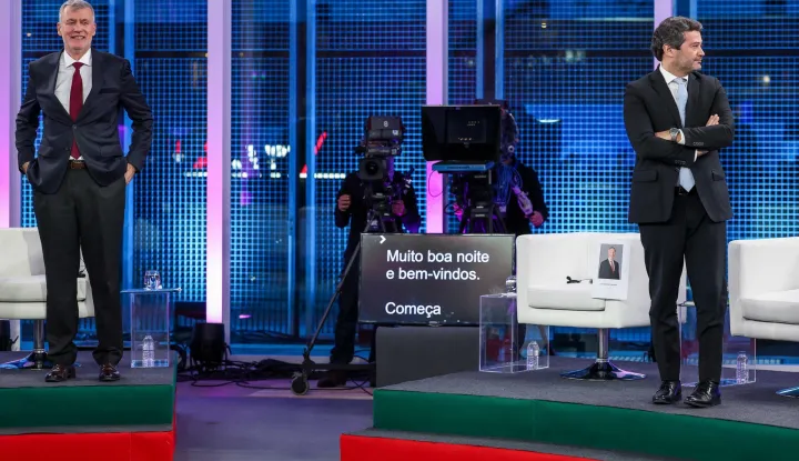 Independent candidate Admiral Henrique Gouveia e Melo (L) gestures next to Chega candidate Andre Ventura before a TV debate with the rest of presidential candidates ahead of the January 18 election, in Lisbon on January 6, 2026. The Portuguese far-right could confirm its recent growth by placing its leader at the head of the first round of the presidential election on January 18, even though Andre Ventura has almost no chance of winning the second round three weeks later. The power of the Portuguese head of state is primarily symbolic, but he may be called upon to act as an arbiter in times of crisis, and holds the power to dissolve Parliament to call for legislative elections. (Photo by PATRICIA DE MELO MOREIRA/AFP)