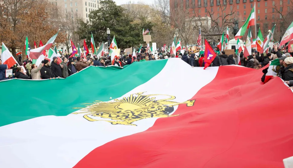 Demonstrators protesting the deadly crackdown in Iran display a large Iranian opposition flag outside the White House in Washington, DC on January 17, 2026. The United States on January 15 said Iran halted 800 executions of protesters under pressure from President Donald Trump, after Gulf allies appeared to pull him back from military action over Tehran's deadly crackdown on demonstrations. Iran was shaken over the last week by some of the biggest anti-government protests in the history of the Islamic republic, although the demonstrations appear to have diminished over the last few days in the face of repression and a week-long internet blackout. (Photo by Amid FARAHI/AFP)