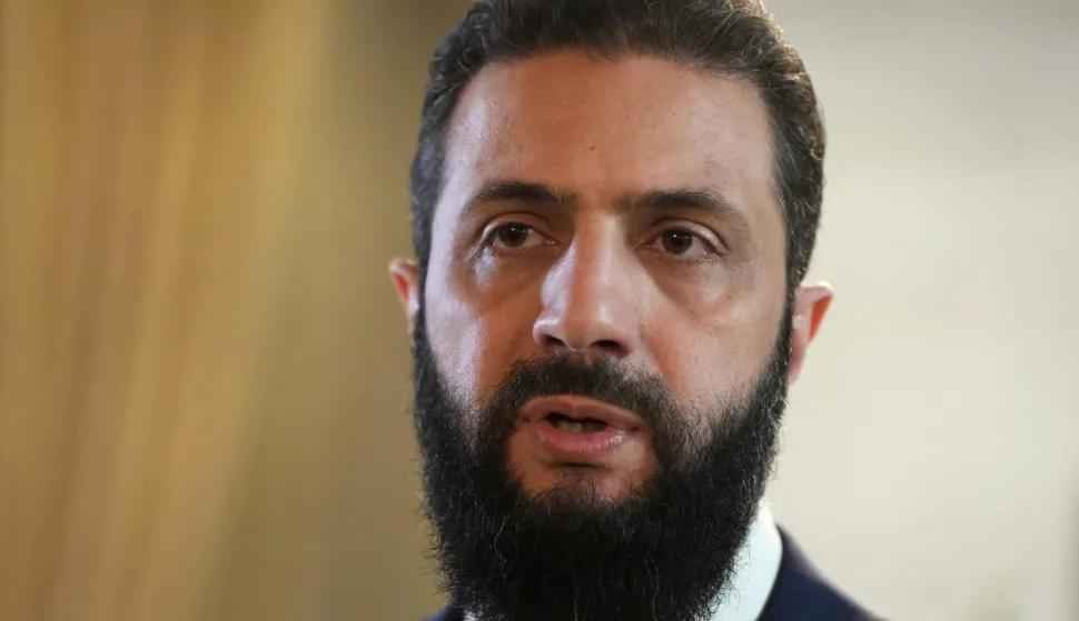 Syria's President Ahmed al-Sharaa speaks after signing an agreement at the Presidential Palace in Damascus on January 18, 2026. Syrian President Ahmed al-Sharaa on January 18, announced an agreement with the chief of the Kurdish-led Syrian Democratic Forces that includes a ceasefire after government forces advanced in Kurdish-held areas of the north and east. (Photo by Handout/AFP)