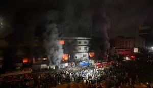 TOPSHOT - Firefighters douse a fire that broke out at a shopping mall in Karachi on January 18, 2026. (Photo by Rizwan TABASSUM/AFP)