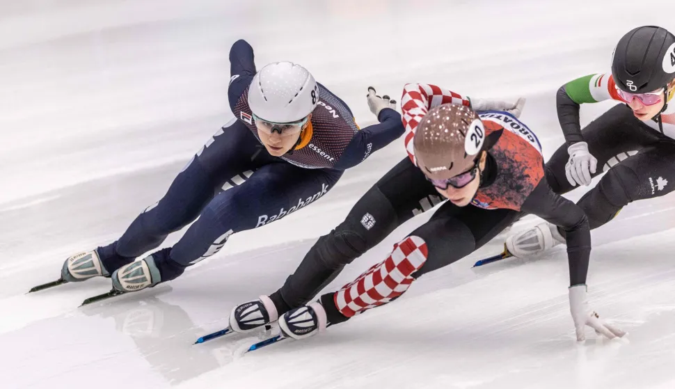 Dutch speed skater Selma Poutsma (L) and Georgian speed skater Valentina Asenc (C) compete in the 1000m quarterfinals on the second day of the European Short Track Speed Skating Championships in Tilburg on January 17, 2026. (Photo by Iris van den Broek/ANP/AFP)/Netherlands OUT