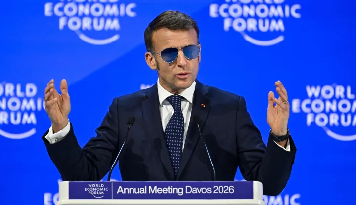 TOPSHOT - France's President Emmanuel Macron gestures as he delivers a speech during the World Economic Forum (WEF) annual meeting in Davos on January 20, 2026. The World Economic Forum takes place in Davos from January 19 to January 23, 2026. (Photo by Fabrice COFFRINI/AFP)