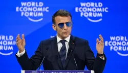 TOPSHOT - France's President Emmanuel Macron gestures as he delivers a speech during the World Economic Forum (WEF) annual meeting in Davos on January 20, 2026. The World Economic Forum takes place in Davos from January 19 to January 23, 2026. (Photo by Fabrice COFFRINI/AFP)