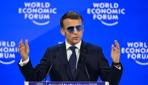 TOPSHOT - France's President Emmanuel Macron gestures as he delivers a speech during the World Economic Forum (WEF) annual meeting in Davos on January 20, 2026. The World Economic Forum takes place in Davos from January 19 to January 23, 2026. (Photo by Fabrice COFFRINI/AFP)